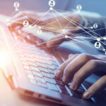 Close up of male hands working on computer keyboard