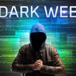 Faceless hacker with DARK WEB inscription on a binary code background